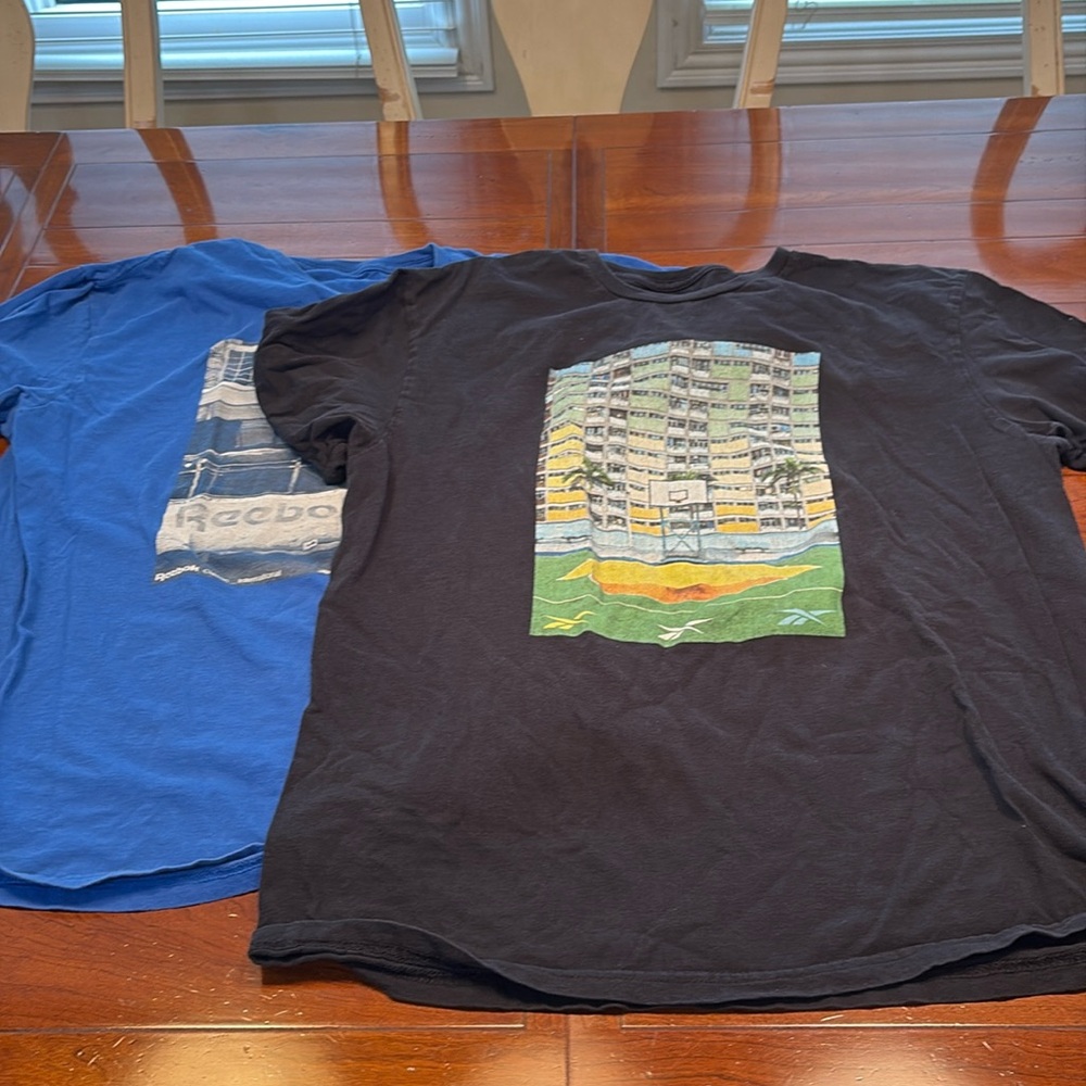 Two men’s Reebok t shirts.